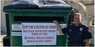 Photo: Chief Foster in front of the Burglar Box Depot at the Coquina Building
